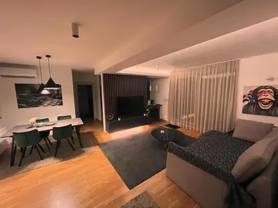 a living room with a couch and a dining room at Penthouse city center in Belgrade