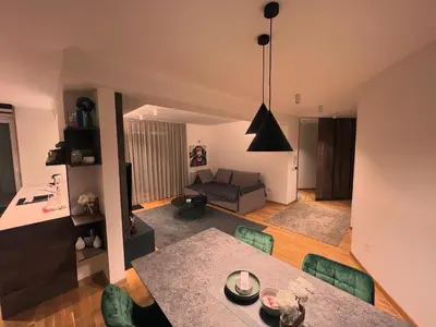 a living room with a table and a couch at Penthouse city center in Belgrade
