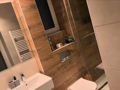 a bathroom with a toilet and a sink and a shower at Penthouse city center in Belgrade