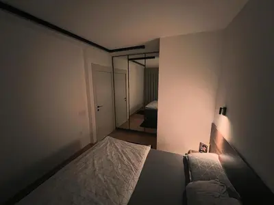 a small bedroom with a bed and a mirror at Penthouse city center in Belgrade