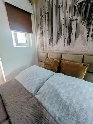 a bedroom with a bed and a painting on the wall at Cosy Central Studio Jana in Belgrade
