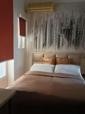 a bedroom with a large bed with a painting on the wall at Cosy Central Studio Jana in Belgrade