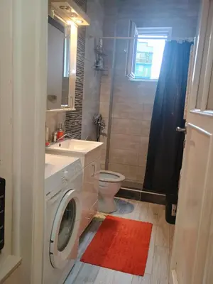 a bathroom with a washing machine and a sink at Cosy Central Studio Jana in Belgrade