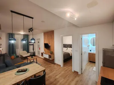 a living room with a couch and a table at Surčin Central Stay in Surčin