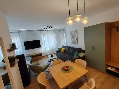 a living room with a table and a couch at Surčin Central Stay in Surčin