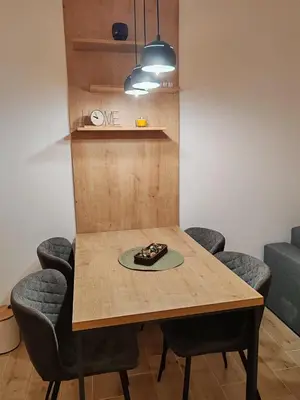 a dining room table with chairs and a plate on it at Surčin Central Stay in Surčin