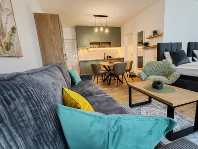 a living room with a couch and a table at Surčin Central Stay in Surčin