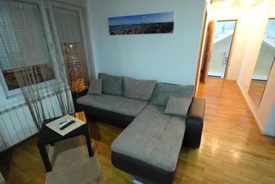 a living room with a couch and a table at Franstal Apartments in Belgrade