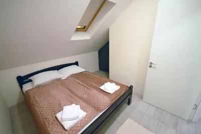 a bedroom with a bed with two white towels on it at Franstal Apartments in Belgrade