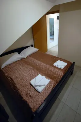 a large bed with two pillows on top of it at Franstal Apartments in Belgrade