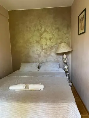 a bedroom with a bed with two towels on it at Front Apartment in Belgrade