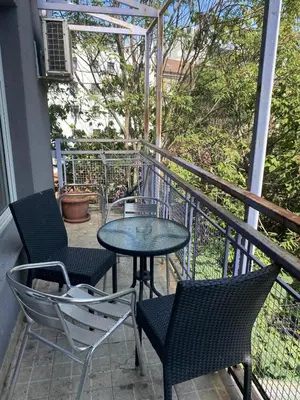 a patio with two chairs and a table on a balcony at Front Apartment in Belgrade