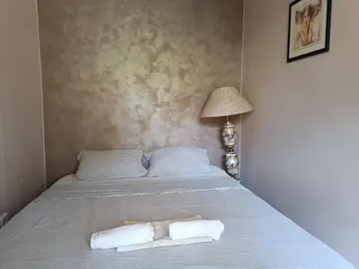 a bed with two towels on it with a lamp at Front Apartment in Belgrade