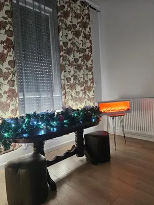 a table with christmas lights on it in front of a window at Miss Lux in Mladenovac