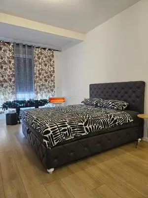 a bedroom with a large bed with a zebra blanket at Miss Lux in Mladenovac