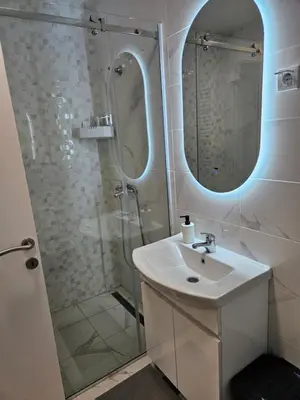 a bathroom with a sink and a shower at Miss Lux in Mladenovac