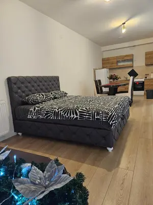 a bedroom with a bed and a christmas tree at Miss Lux in Mladenovac