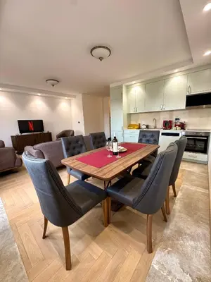 a kitchen and dining room with a wooden table and chairs at ATHOS Luxury Stay - Luxury and Comfort in the Center of Zvezdara in Belgrade