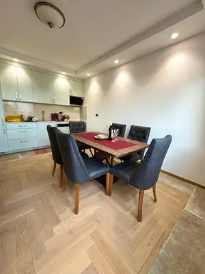 a dining room with a wooden table and chairs at ATHOS Luxury Stay - Luxury and Comfort in the Center of Zvezdara in Belgrade