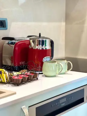 a red toaster sitting on top of a counter at ATHOS Luxury Stay - Luxury and Comfort in the Center of Zvezdara in Belgrade