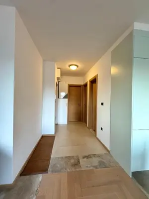 a hallway of a house with white walls and wooden floors at ATHOS Luxury Stay - Luxury and Comfort in the Center of Zvezdara in Belgrade