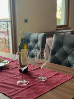a bottle of wine and two wine glasses on a table at ATHOS Luxury Stay - Luxury and Comfort in the Center of Zvezdara in Belgrade