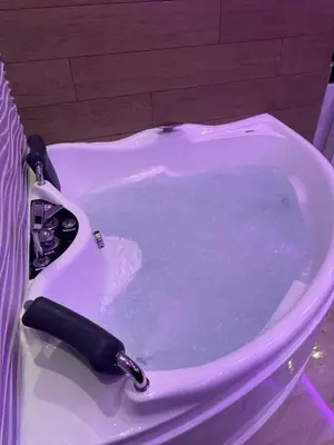 a bath tub filled with water in a bathroom at Apartman Andrej in Belgrade