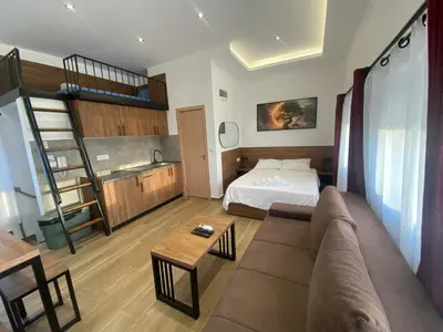 a living room with a couch and a bed at M Corner in Belgrade