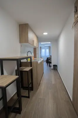 a kitchen with wooden cabinets and a counter top at M Corner in Belgrade
