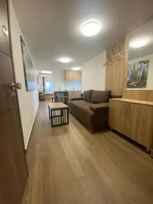 a living room with a couch and a table at M Corner in Belgrade