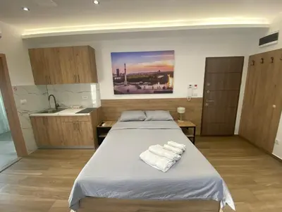 a bedroom with a bed with towels on it at M Corner in Belgrade