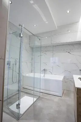 a bathroom with a shower and a bath tub at M Corner in Belgrade