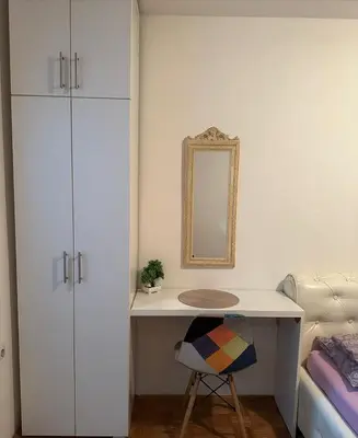 a bedroom with a desk with a mirror and a bed at Kosovska Street in Belgrade