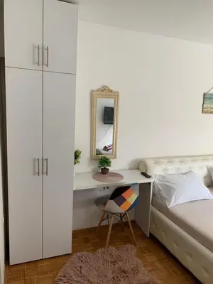 a bedroom with a bed and a desk with a mirror at Kosovska Street in Belgrade