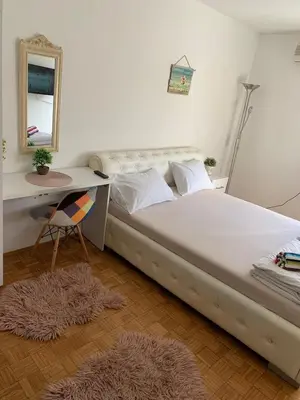 a bedroom with a bed with a desk and a mirror at Kosovska Street in Belgrade