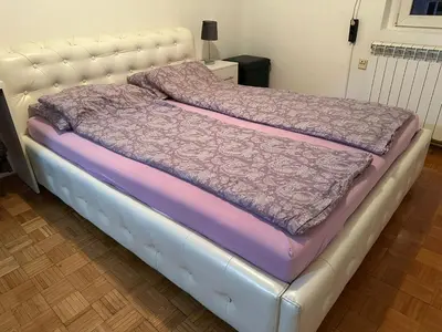 a bed in a room with a white bed frame at Kosovska Street in Belgrade