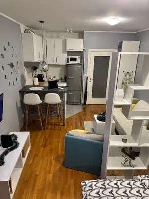 a small kitchen and living room with a staircase in a room at Marse Stay in Belgrade