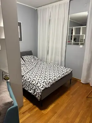 a small bedroom with a bed in a room at Marse Stay in Belgrade