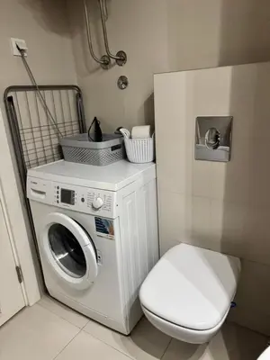 a washing machine and a toilet in a bathroom at Marse Stay in Belgrade