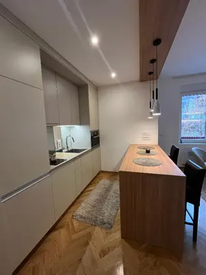 a kitchen with a wooden island in a room at Skadarlija Urban Nest in Belgrade