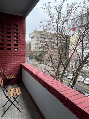 a balcony with a red brick wall and two benches at Skadarlija Urban Nest in Belgrade