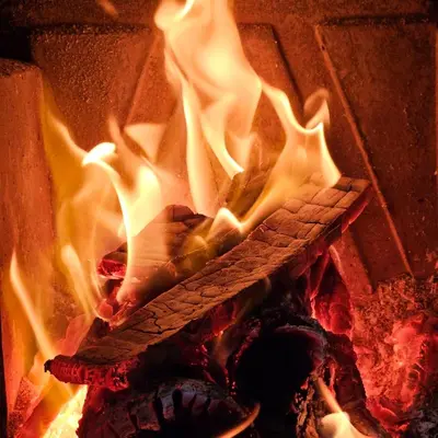 a fire in a brick oven with flames at Diamond House Rent Vikendica in Beška