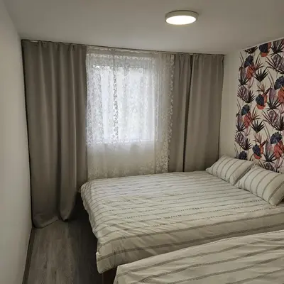 a bed in a room with a window at Diamond House Rent Vikendica in Beška