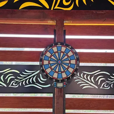 a dart board on a pole in front of a wall at Diamond House Rent Vikendica in Beška