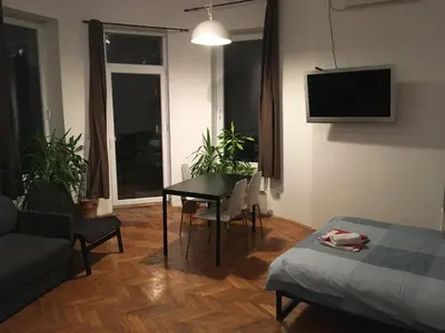 a living room with a table and a couch at Apartman Jovanovic in Belgrade