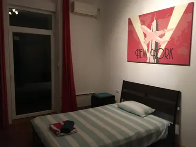 a bedroom with a bed with a hat and a window at Apartman Jovanovic in Belgrade