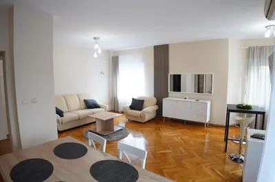 a living room with a couch and a table at Apartmani Kula in Novi Banovci