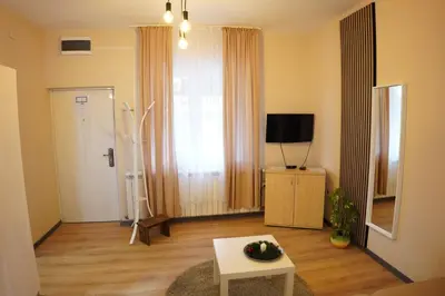 a living room with a table and a tv at Apartmani Kula Novi Banovci Svetosavska 137 in Belgrade