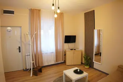 a living room with a tv and a white table at Apartmani Kula Novi Banovci Svetosavska 137 in Belgrade