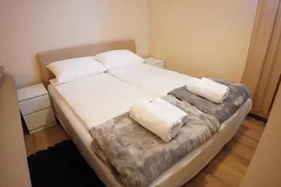 a bed with two pillows on it in a room at Apartmani Kula Novi Banovci Svetosavska 137 in Belgrade